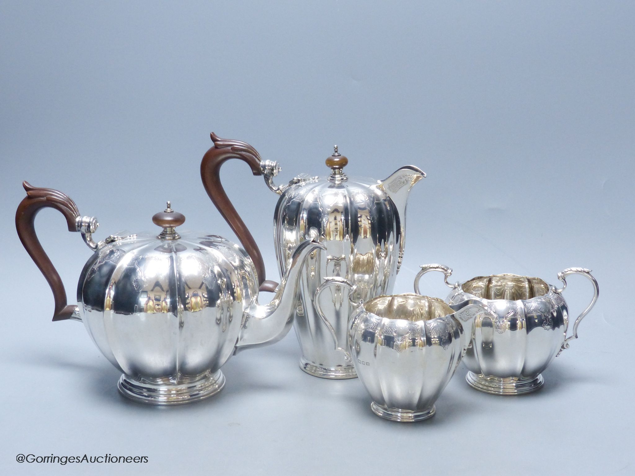 A George V engraved fluted silver four piece silver tea set by Adie Bros, London, 1923,27,28